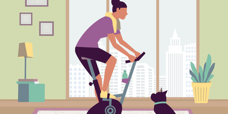 person in living room on exercise bike to burn stomach fat